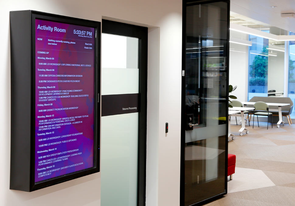 Graphic design, QUT HiQ portrait digital signage with content by Maya Walker next to study room